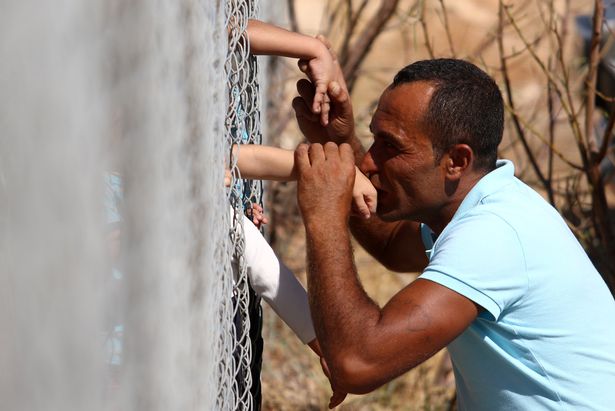 prod-ammar-hammasho-from-syria-who-lives-in-cyprus-kisses-his-children-who-arrived-at-the-refugee-camp-in-(1).jpg