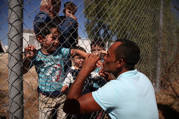 prod-ammar-hammasho-from-syria-who-lives-in-cyprus-kisses-his-children-who-arrived-at-the-refugee-camp-in.jpg